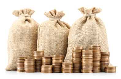 Photo of Bags and stacked coins isolated on white