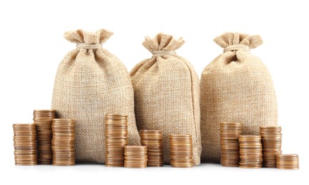 Photo of Bags and stacked coins isolated on white