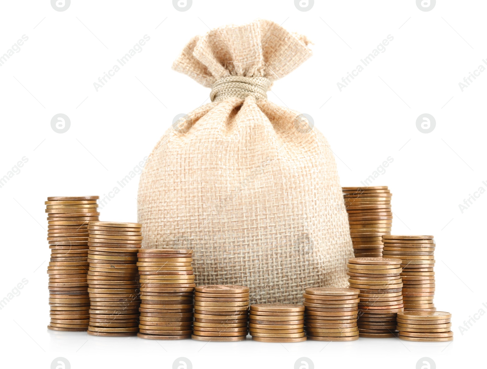 Bag and stacked coins isolated on white Photo of Bag and stacked coins isolated on white