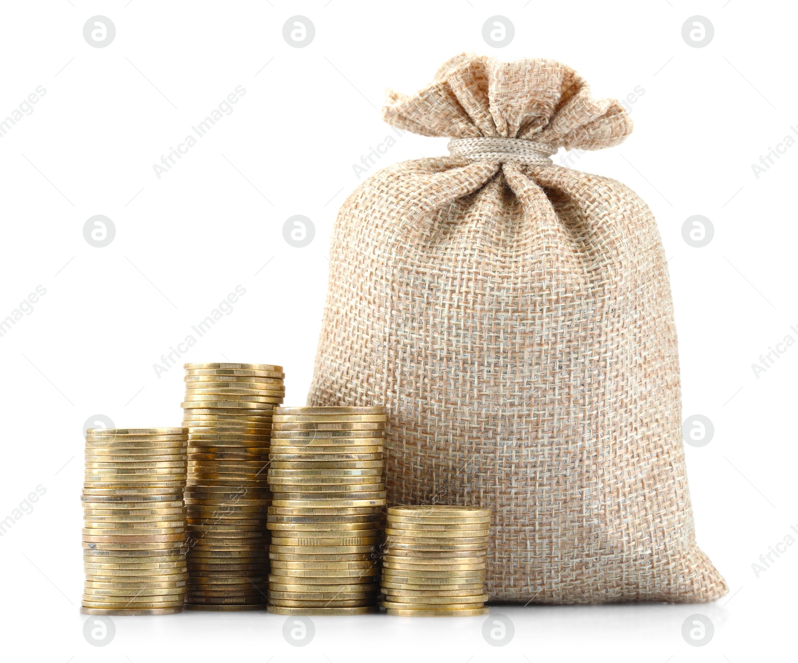 Bag and stacked coins isolated on white Photo of Bag and stacked coins isolated on white