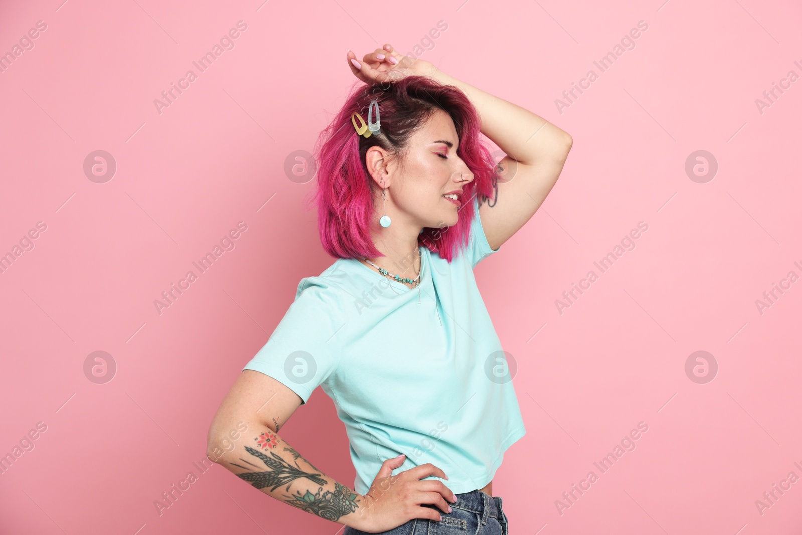 Beautiful woman with bright dyed hair on pink background Photo of Beautiful woman with bright dyed hair on pink background