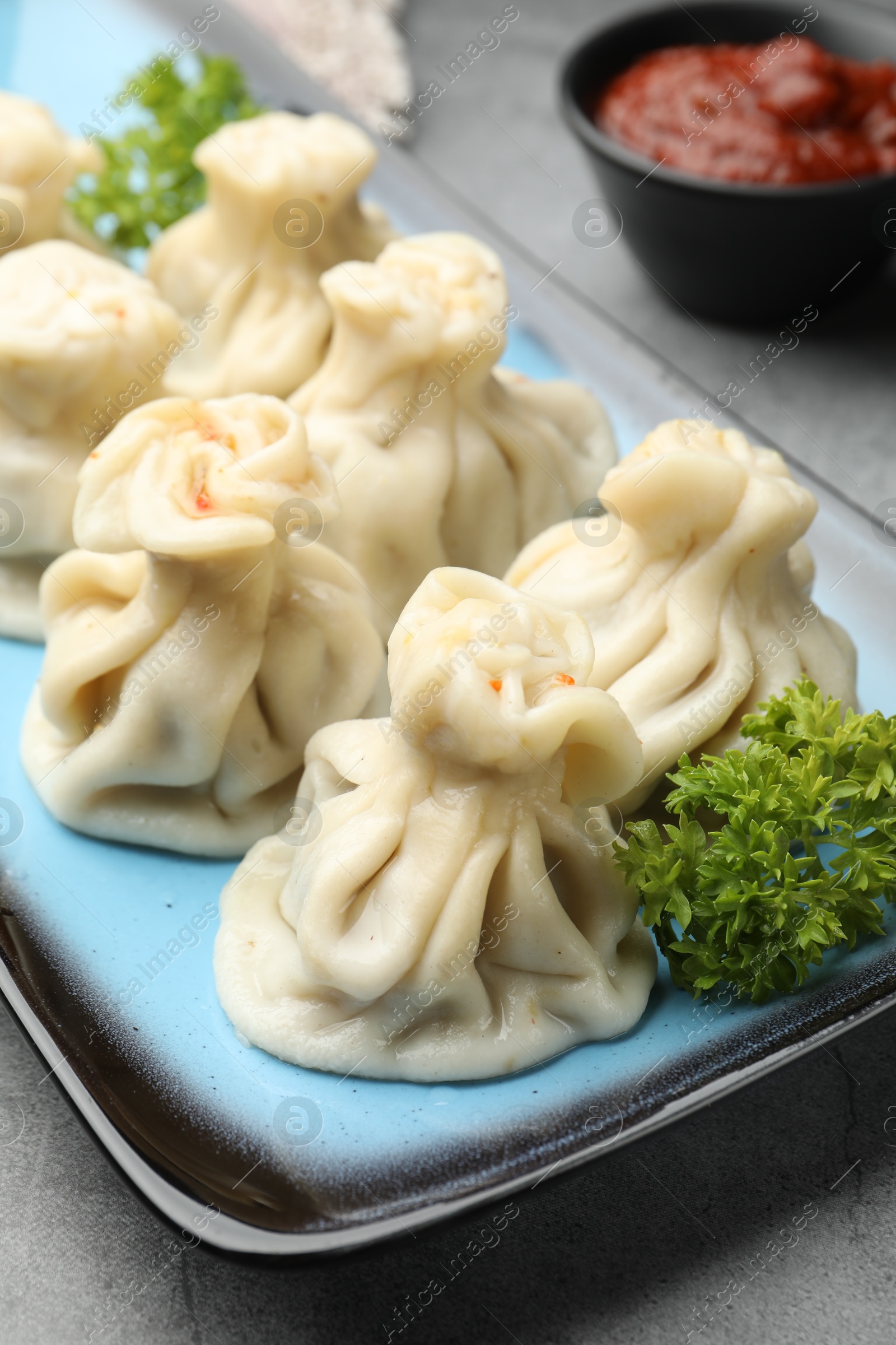 Delicious khinkali served on grey table, closeup Photo of Delicious khinkali served on grey table, closeup