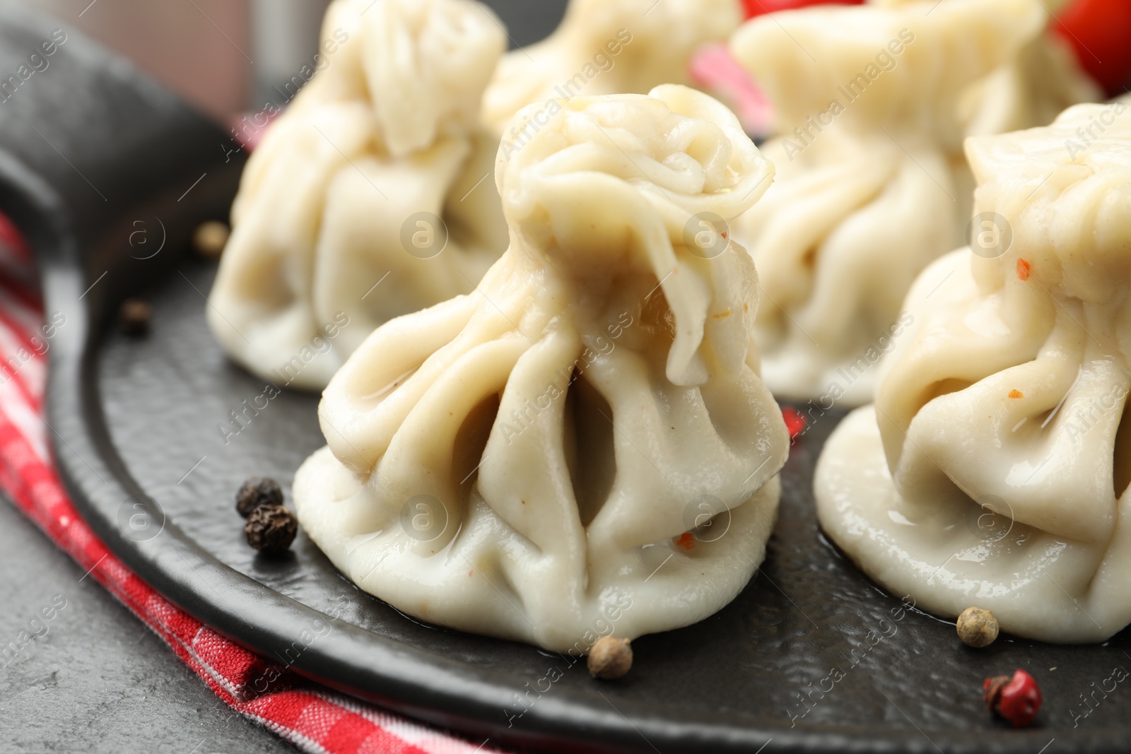 Delicious khinkali with spices on table, closeup Photo of Delicious khinkali with spices on table, closeup
