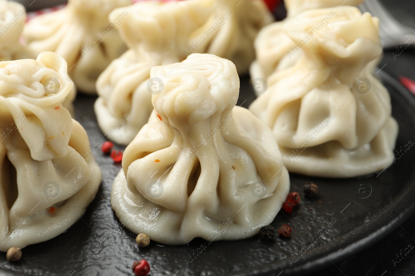 Delicious khinkali with spices on table, closeup Photo of Delicious khinkali with spices on table, closeup