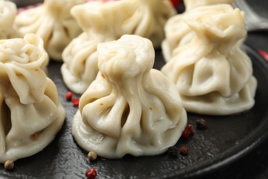 Photo of Delicious khinkali with spices on table, closeup