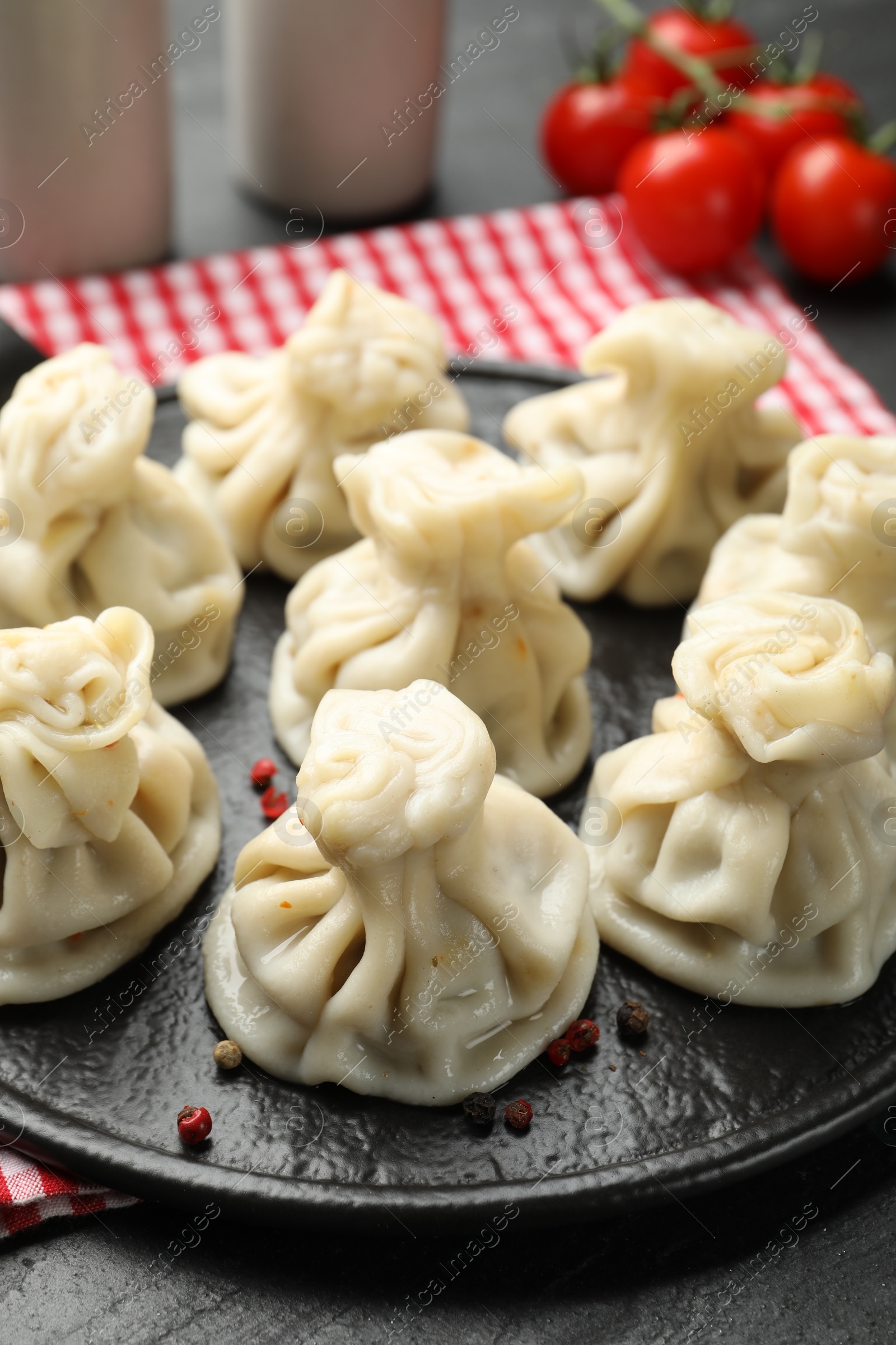 Delicious khinkali served on black table, closeup Photo of Delicious khinkali served on black table, closeup