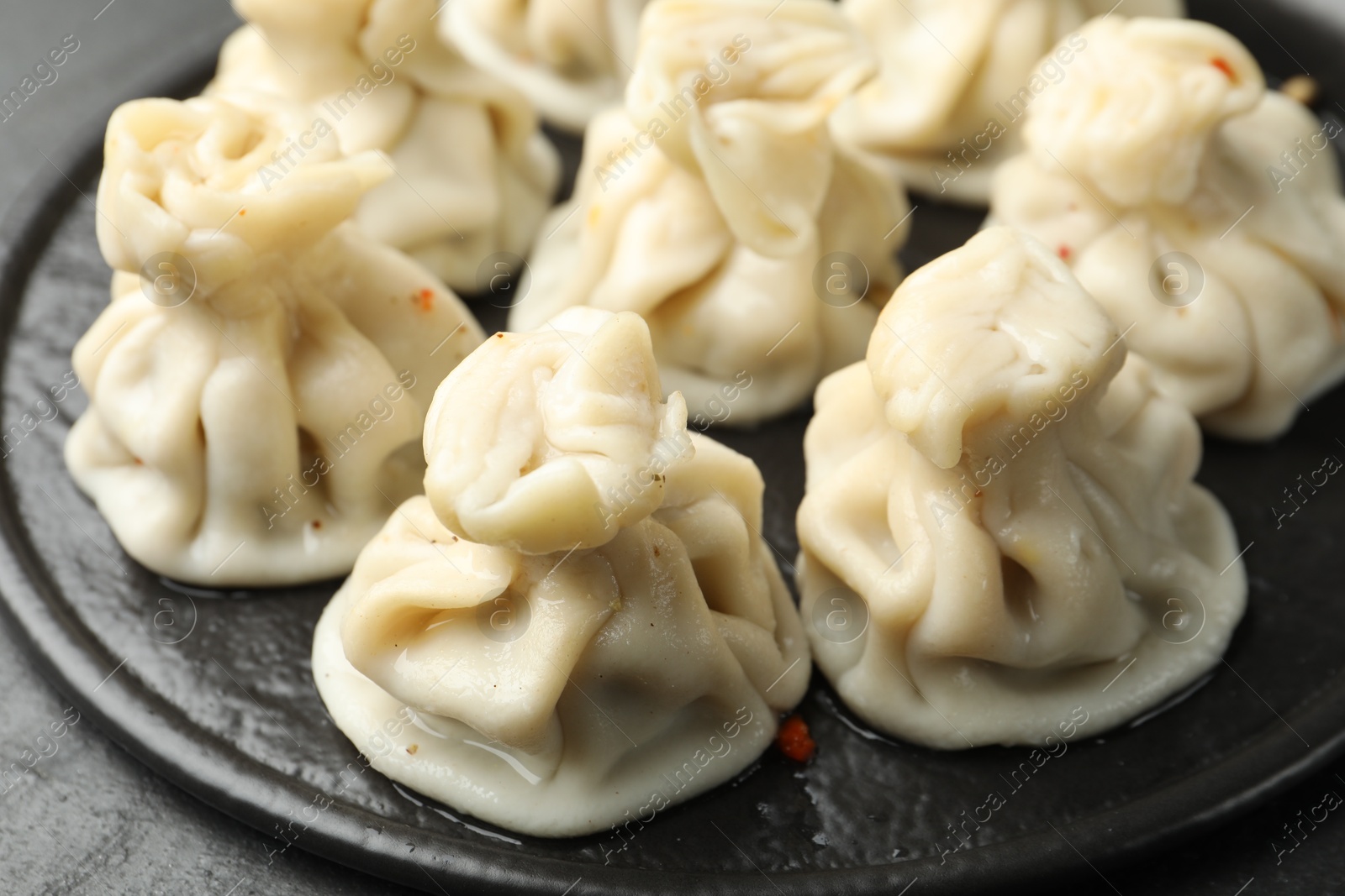 Delicious khinkali with spices on table, closeup Photo of Delicious khinkali with spices on table, closeup