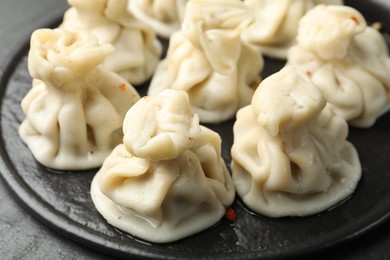 Photo of Delicious khinkali with spices on table, closeup