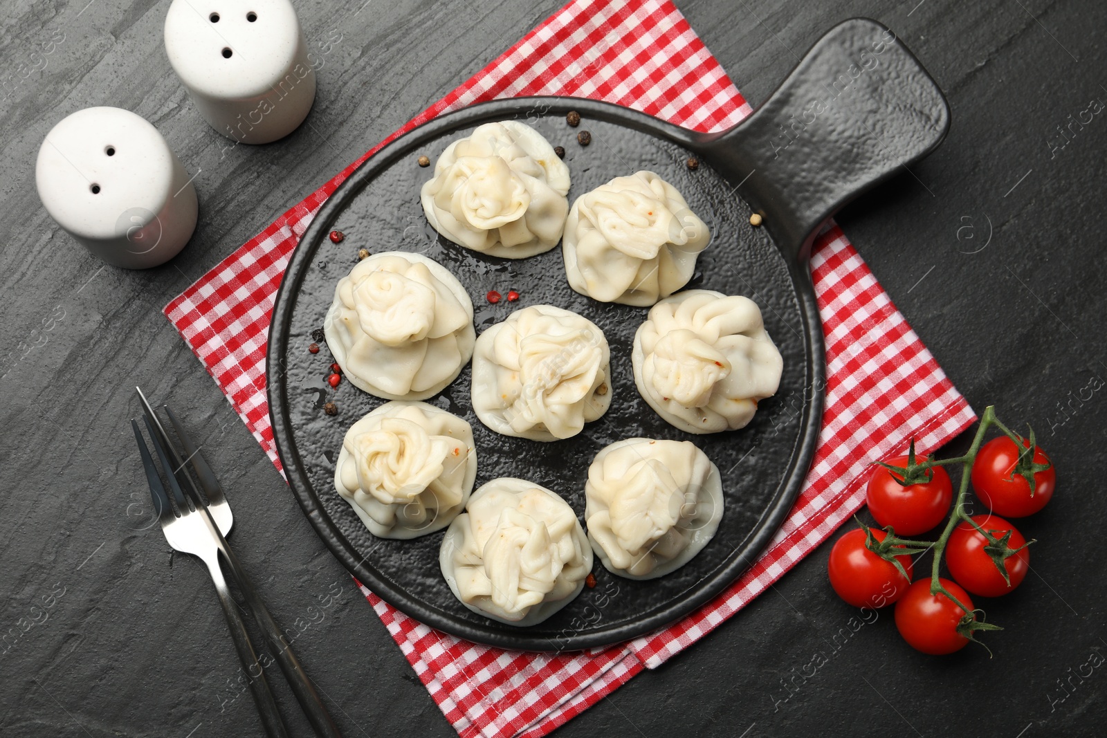 Delicious khinkali served on black table, flat lay Photo of Delicious khinkali served on black table, flat lay