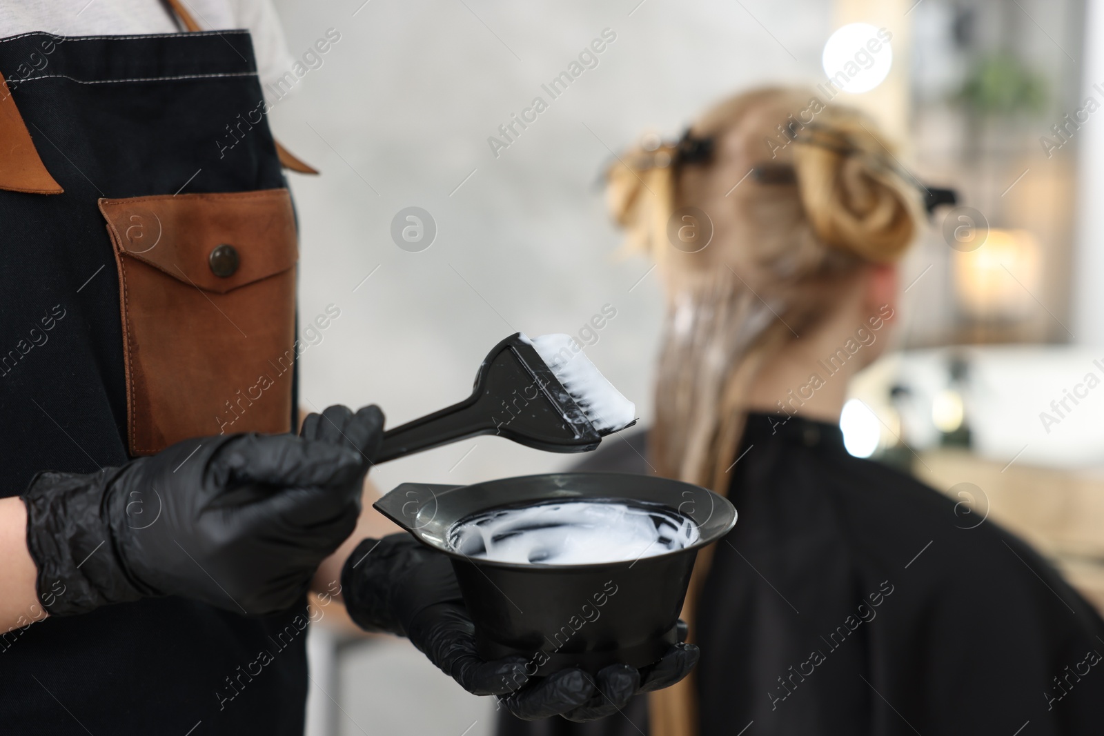 Hairdresser applying dye on woman's hair in salon, closeup Photo of Hairdresser applying dye on woman's hair in salon, closeup