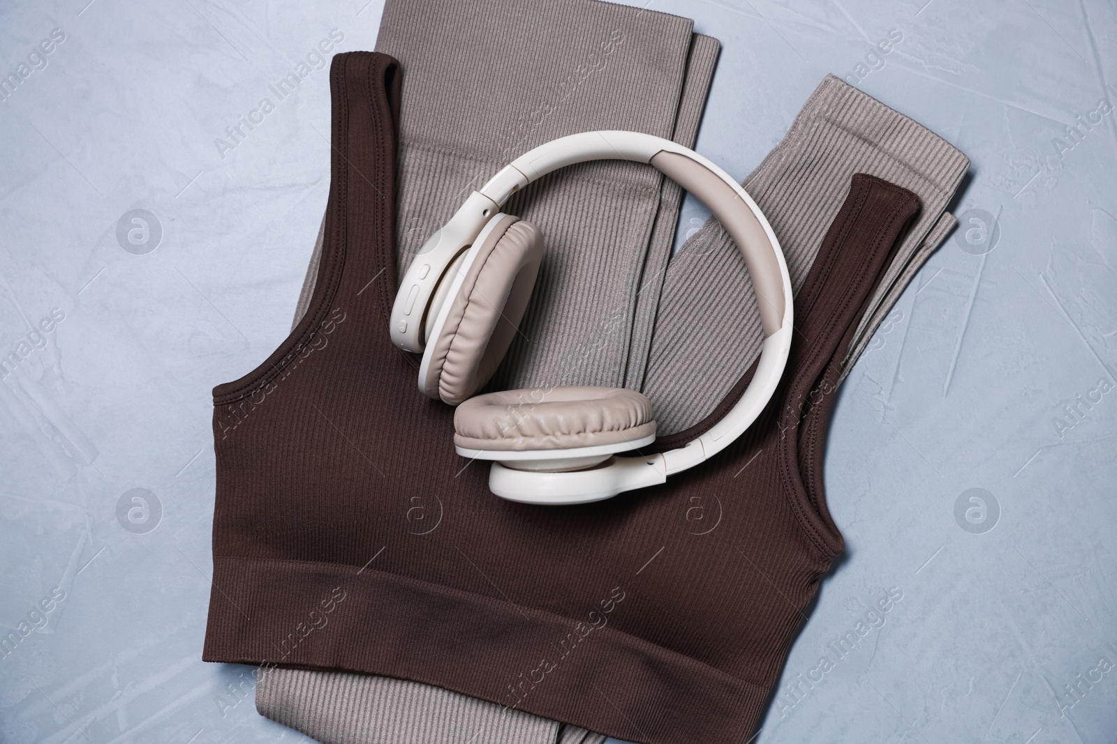 Sportswear and headphones on gray textured background, top view Photo of Sportswear and headphones on gray textured background, top view