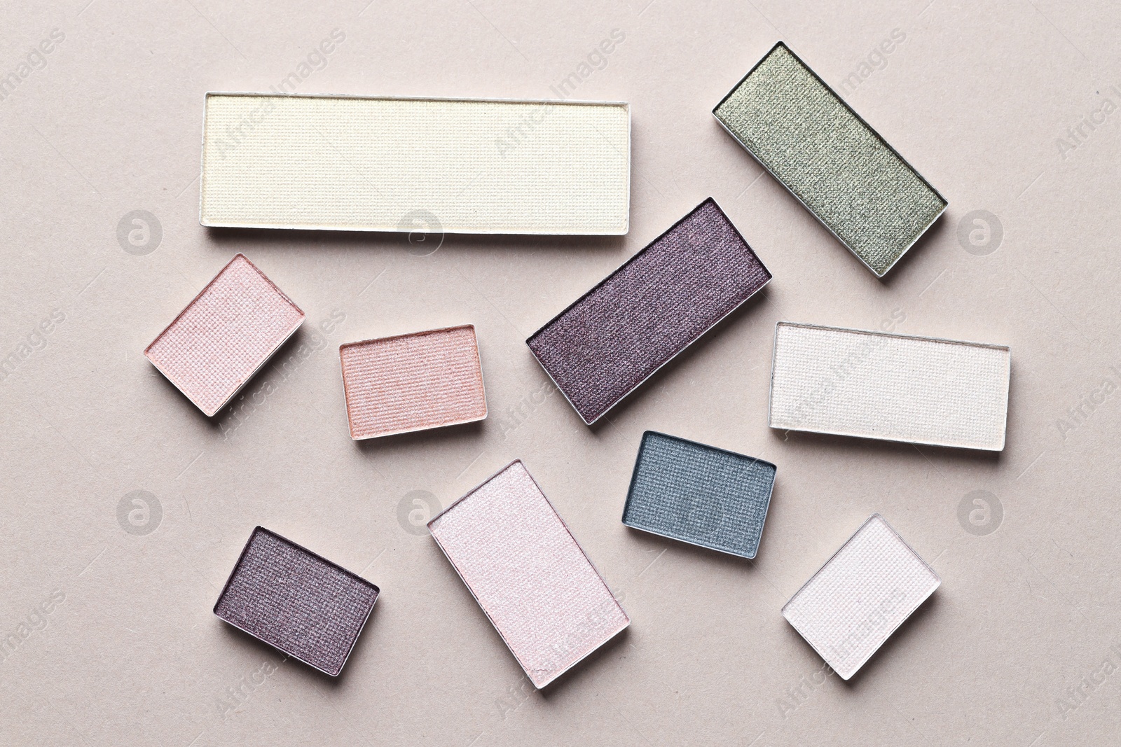 Beautiful eyeshadow refill pans on beige background, flat lay Photo of Beautiful eyeshadow refill pans on beige background, flat lay