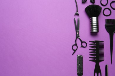 Photo of Different hairdresser's tools on violet background, flat lay. Space for text