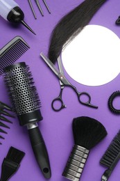Photo of Different hairdresser's tools on purple background, flat lay