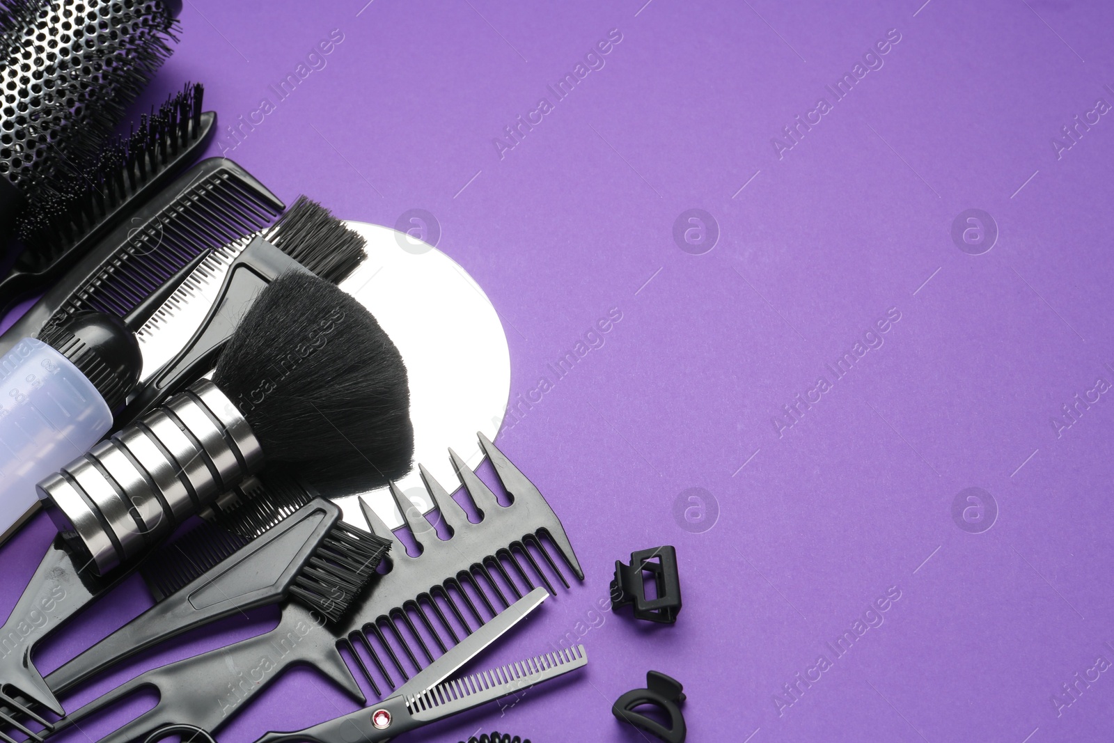Different hairdresser's tools on purple background, above view. Space for text Photo of Different hairdresser's tools on purple background, above view. Space for text