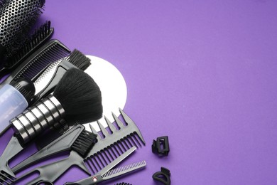 Photo of Different hairdresser's tools on purple background, above view. Space for text