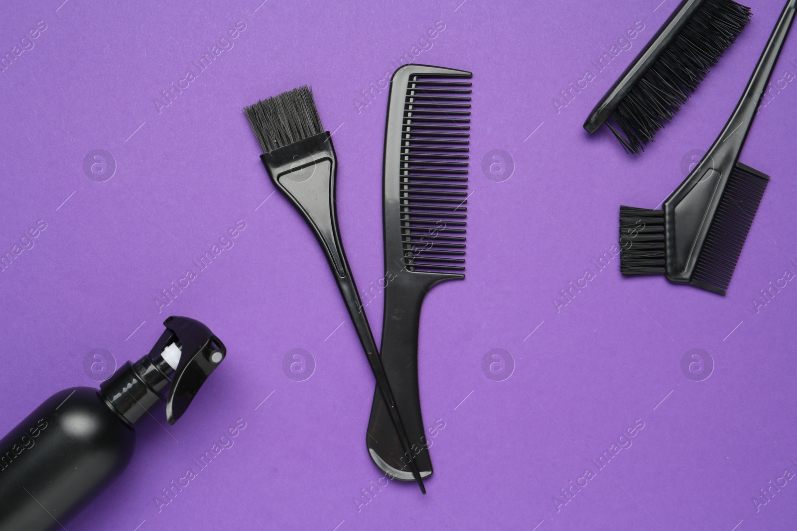 Different hairdresser's tools on purple background, flat lay Photo of Different hairdresser's tools on purple background, flat lay