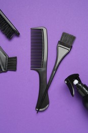 Photo of Different hairdresser's tools on purple background, flat lay