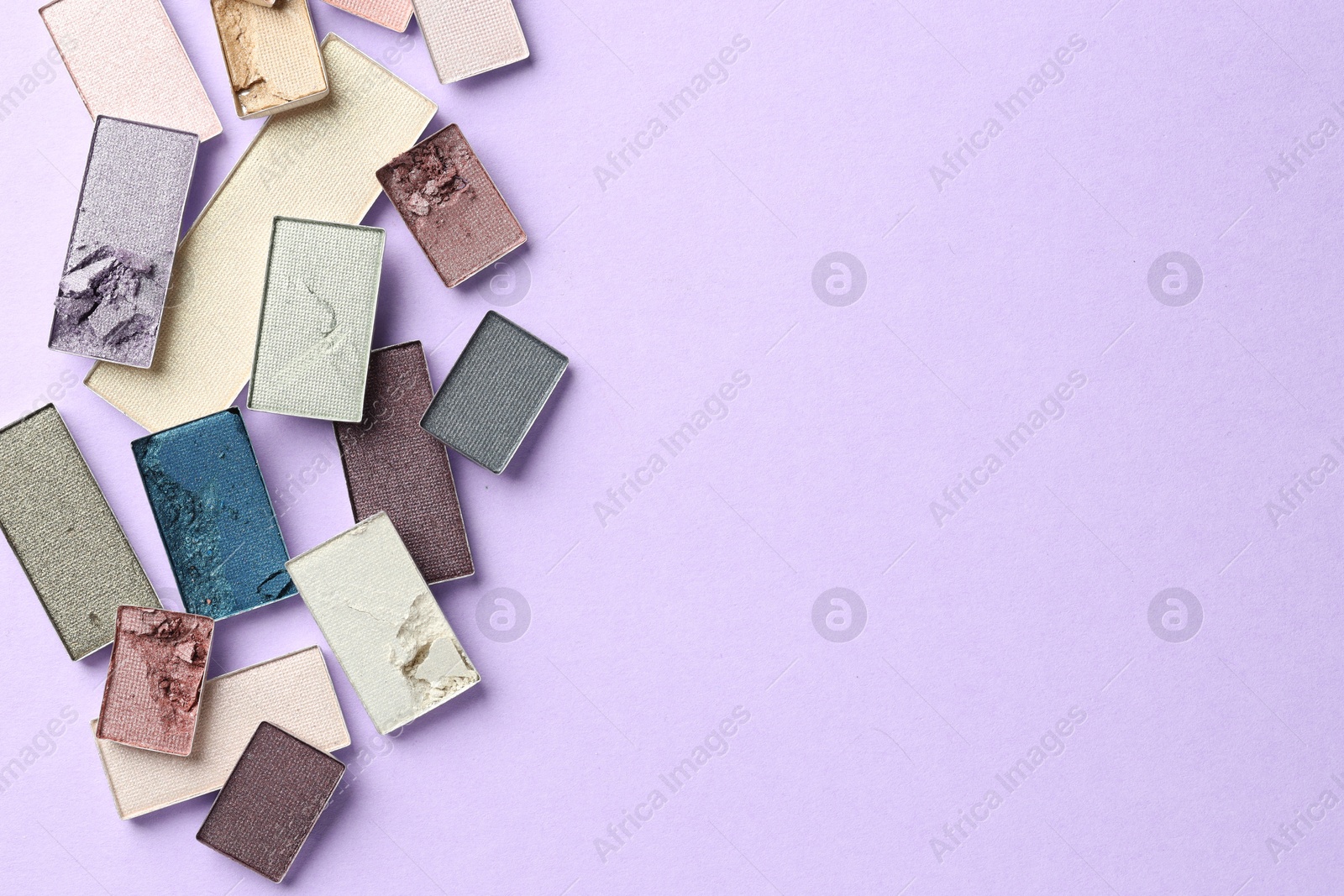 Beautiful eyeshadow refill pans on lilac background, flat lay. Space for text Photo of Beautiful eyeshadow refill pans on lilac background, flat lay. Space for text