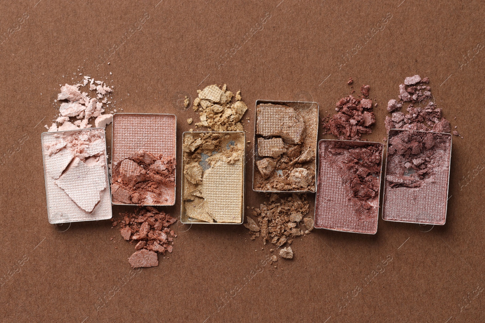 Beautiful eyeshadow refill pans on brown background, flat lay Photo of Beautiful eyeshadow refill pans on brown background, flat lay