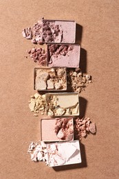 Photo of Beautiful eyeshadow refill pans on brown background, flat lay