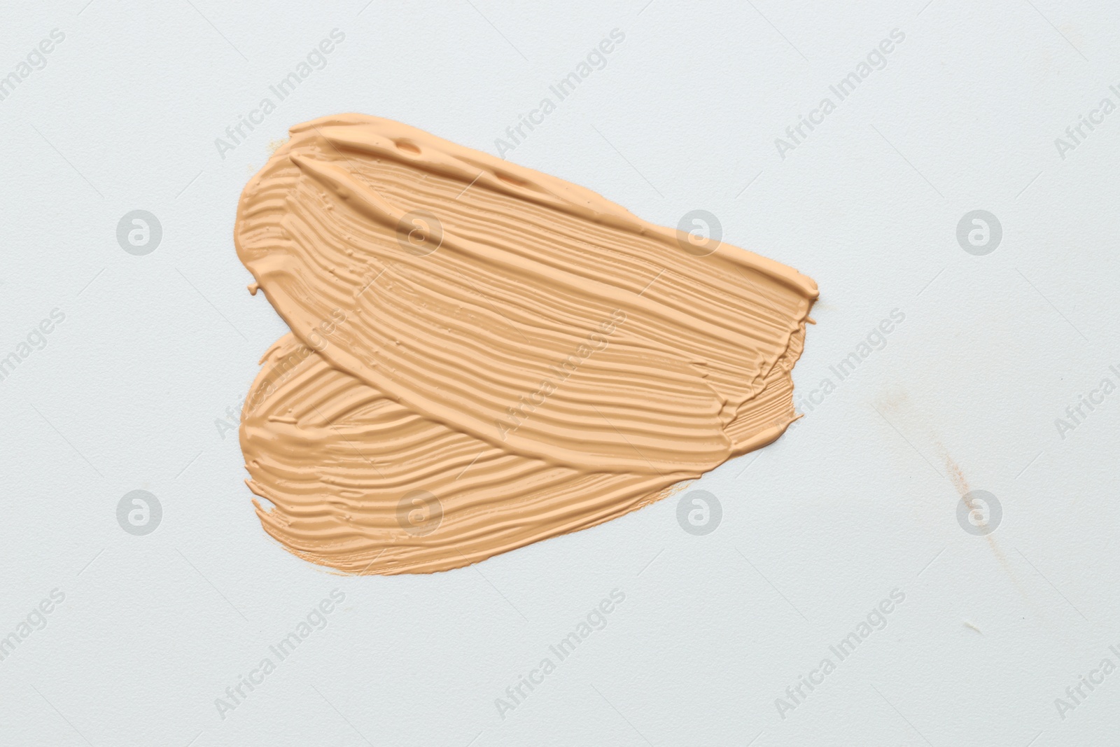 Photo of Sample of foundation on white background, top view