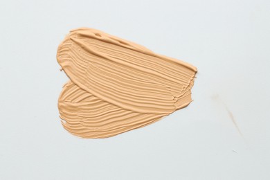 Photo of Sample of foundation on white background, top view
