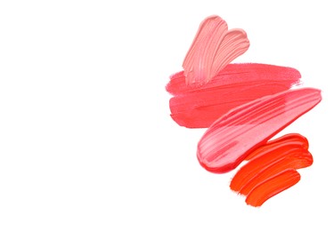 Photo of Samples of different lipsticks isolated on white, top view