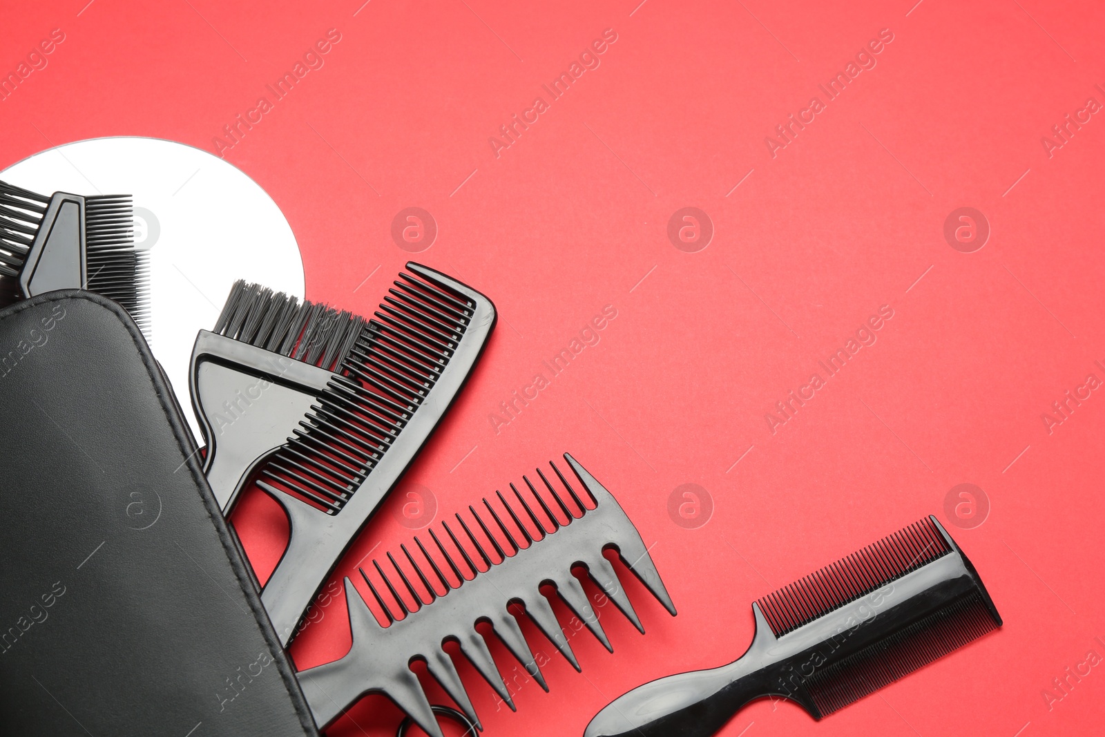 Photo of Different hairdresser's tools on red background, above view. Space for text