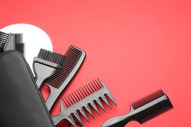 Photo of Different hairdresser's tools on red background, above view. Space for text