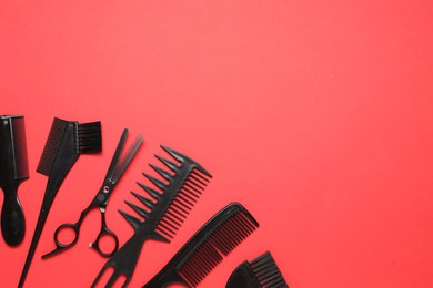 Photo of Different hairdresser's tools on red background, flat lay. Space for text