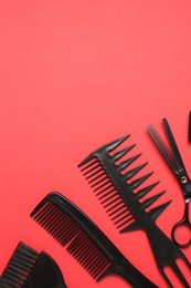 Photo of Different hairdresser's tools on red background, flat lay. Space for text