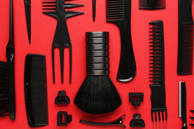 Photo of Different hairdresser's tools on red background, flat lay