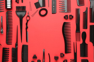 Photo of Frame of different hairdresser's tools on red background, flat lay. Space for text