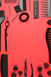 Photo of Frame of different hairdresser's tools on red background, flat lay. Space for text