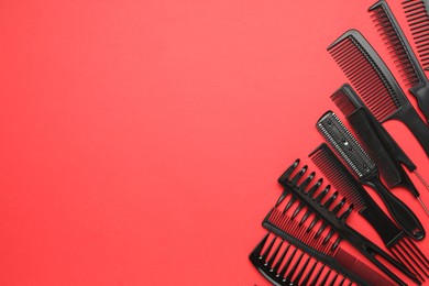 Photo of Different hairdresser's tools on red background, flat lay. Space for text