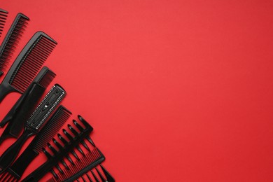 Photo of Different hairdresser's tools on red background, flat lay. Space for text