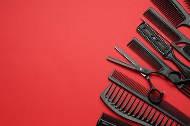 Photo of Different hairdresser's tools on red background, above view. Space for text