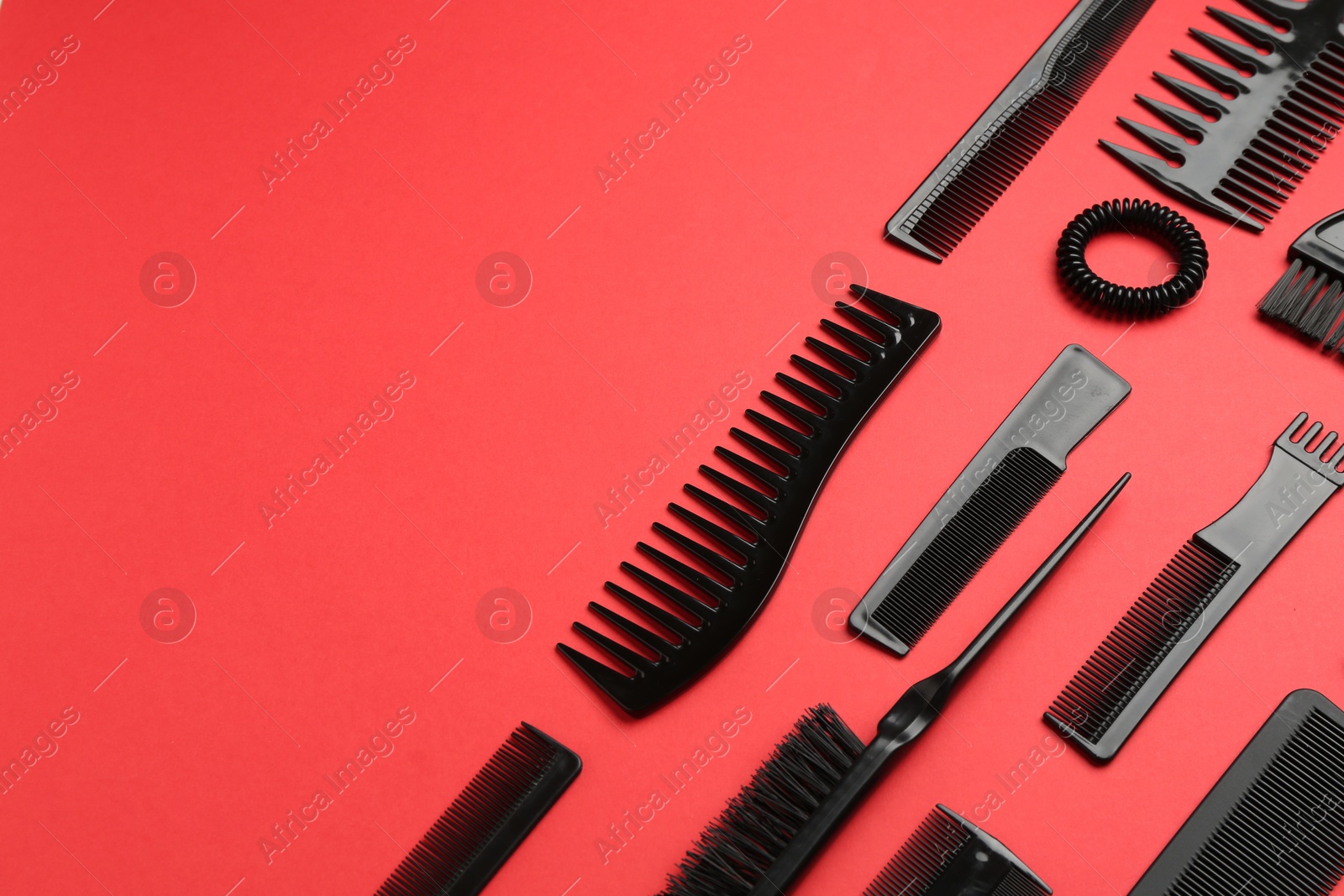 Photo of Different hairdresser's tools on red background, above view. Space for text