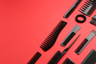 Photo of Different hairdresser's tools on red background, above view. Space for text