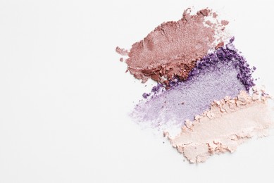 Photo of Samples of beautiful eyeshadows on white background, top view. Space for text