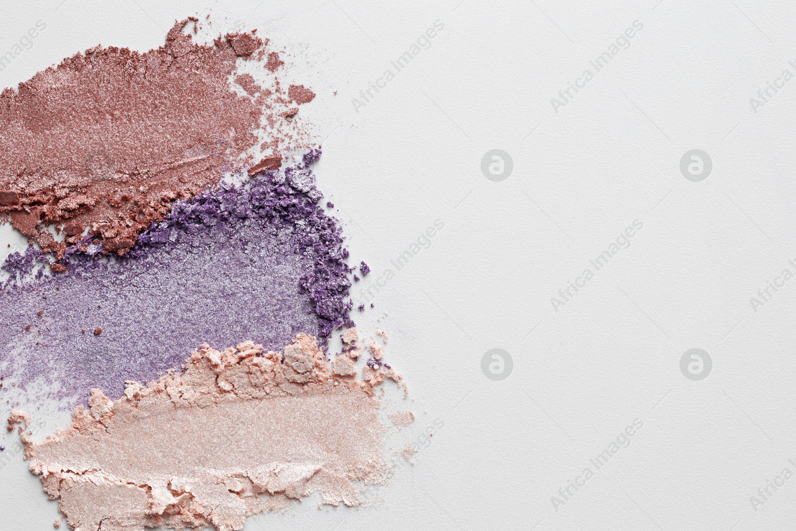 Samples of beautiful eyeshadows on white background, top view. Space for text Photo of Samples of beautiful eyeshadows on white background, top view. Space for text