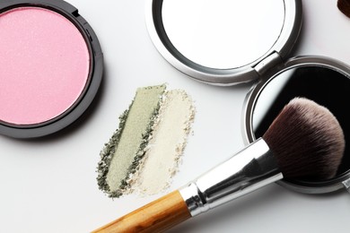 Photo of Different makeup products and brush on white background, flat lay