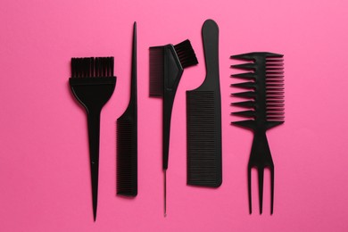 Photo of Different hairdresser's tools on pink background, flat lay