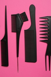 Photo of Different hairdresser's tools on pink background, flat lay