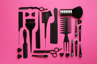 Photo of Different hairdresser's tools on pink background, flat lay
