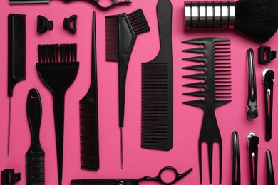 Photo of Different hairdresser's tools on pink background, flat lay