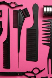 Photo of Different hairdresser's tools on pink background, flat lay