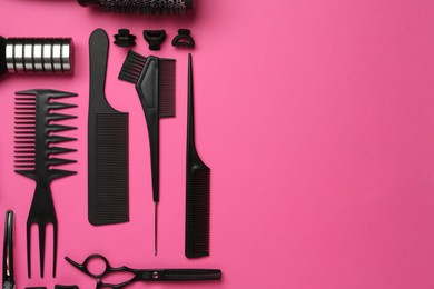 Photo of Different hairdresser's tools on pink background, flat lay. Space for text