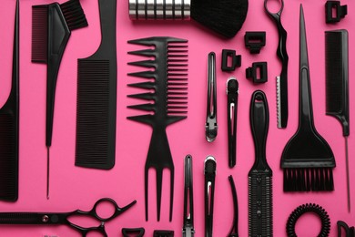 Photo of Different hairdresser's tools on pink background, flat lay